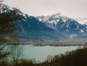 Scenic view of lake and mountains against sky during winter