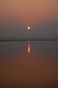 Scenic view of sea against orange sky