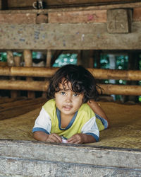 Portrait of cute boy sitting on table
