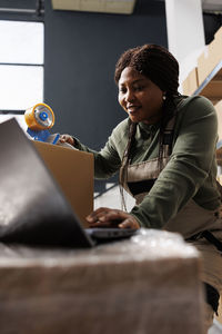 Portrait of young woman using digital tablet