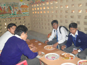 Group of people eating food in restaurant