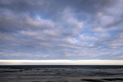 Scenic view of beach against blue sky