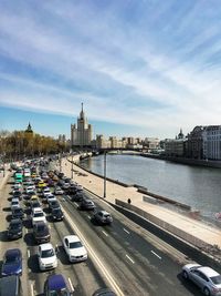 High angle view of traffic on road by buildings against sky