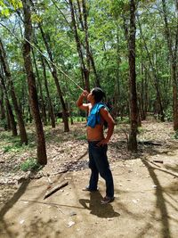 Full length of man standing in forest