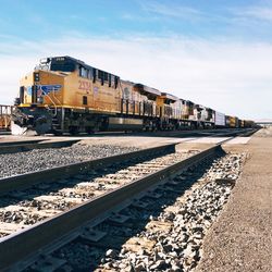 Train on railroad track against sky