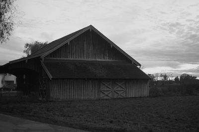 Exterior of house on field against sky