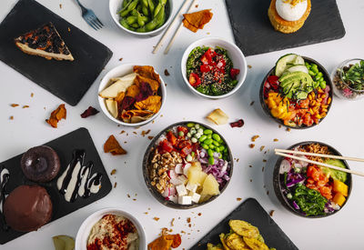 Variety of healthy and delicious poke basins on the restaurant table