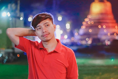 Portrait of young man looking away outdoors