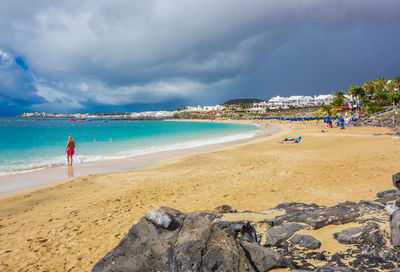 View of beach against cloudy sky