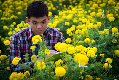 Portrait of man with yellow flowers