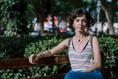 Woman sitting on bench at park