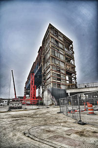 Construction site by building against sky