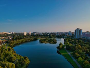 High angle view of river amidst buildings against clear sky