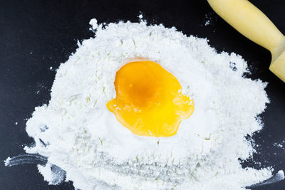 High angle view of yellow egg on black background