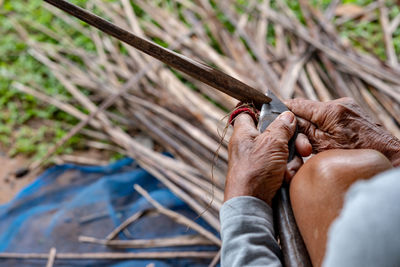 Low section of man holding wood