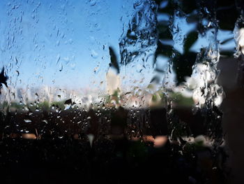 Close-up of wet glass window in rainy season