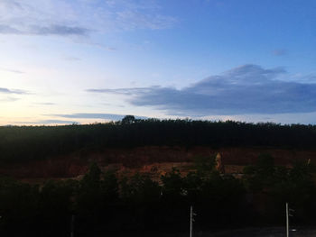 Scenic view of field against sky at sunset