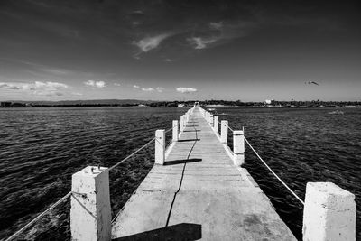 Pier over sea against sky