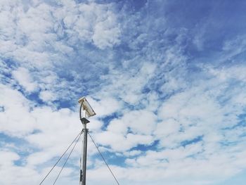 Low angle view of windmill against sky