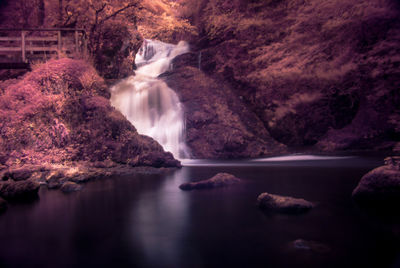 Scenic view of waterfall against sky