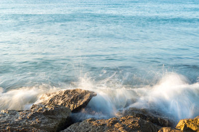 Waves splashing on rocks at shore