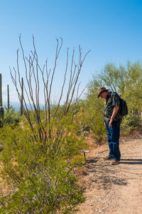 Full length of man standing on land against sky