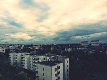 Cityscape against cloudy sky