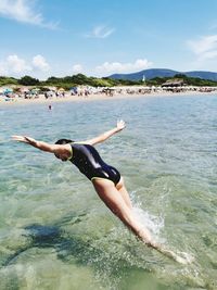 Man surfing in sea against sky