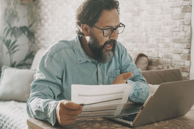 Young man using laptop at home