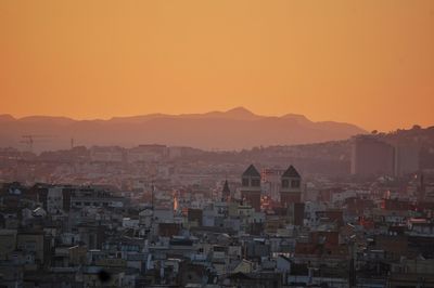 High angle view of townscape against orange sky