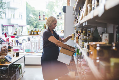 Midsection of woman standing at store