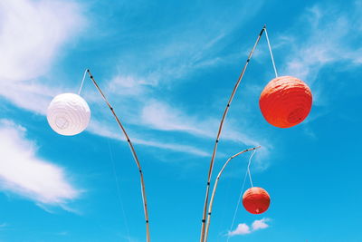 Low angle view of balloons against sky