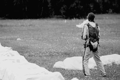 Rear view of boy walking on field