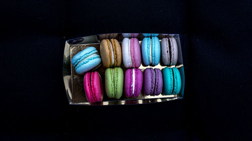 Close-up of multi colored candies against black background