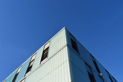 Low angle view of building against clear blue sky