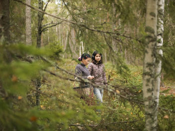 Portrait of woman standing in forest