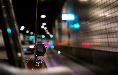 Close-up of illuminated lighting equipment on road