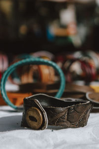 Close-up of leather bracelet on table