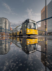 Reflection of building in puddle on street