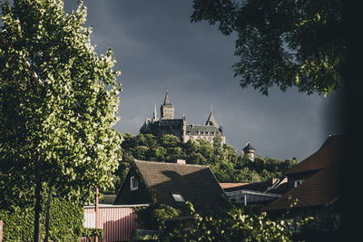 Panoramic view of trees and buildings against sky