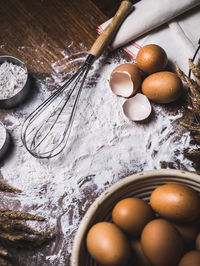 High angle view of eggs with flour on table