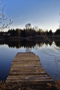 Pier over lake against sky