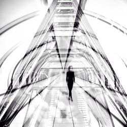 Low angle view of woman standing in modern building