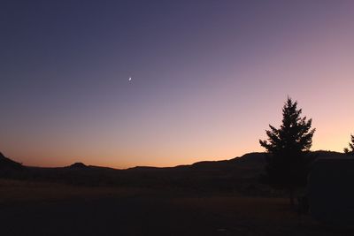 Scenic view of silhouette landscape against clear sky at sunset