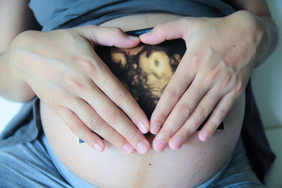 Midsection of couple holding baby