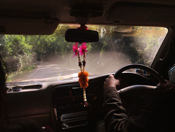 Cropped hands of person driving car