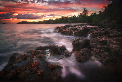 View of sea against dramatic sky during sunset