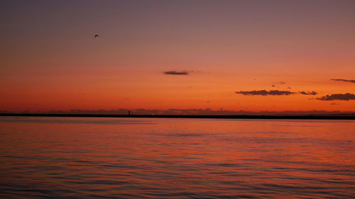 Scenic view of sea against orange sky