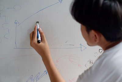 Midsection of child holding paper with text
