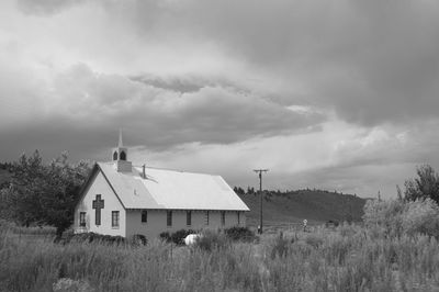 Houses on field against sky